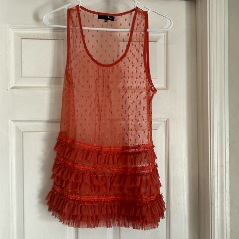 Orange see through top.